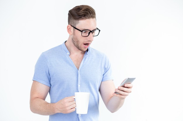 surprised-young-man-glasses-using-smartphone_1262-5875